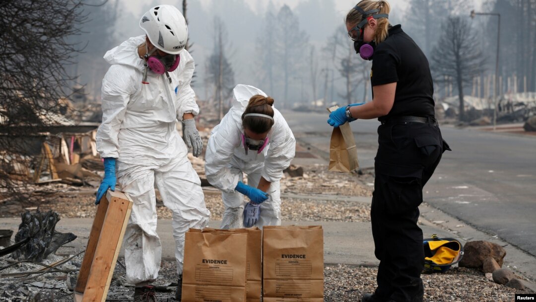 Forensic anthropologists Kyra Stull and Tatiana Vlemincq work with San Mateo County Deputy Coroner Elizabeth Ortiz to recover human remains from a trailer home destroyed by the Camp Fire in Paradise, California, U.S., November 17, 2018.