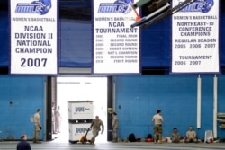 FILE - Connecticut National Guard personnel unload supplies provided by FEMA to the state for a "surge" hospital during the coronavirus crisis, at Southern Connecticut State University's Moore Field House in New Haven, Conn., March 31, 2020.