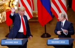FINLAND -- U.S. President Donald Trump and Russian President Vladimir Putin react at the end of the joint news conference after their meeting in Helsinki, July 16, 2018.
