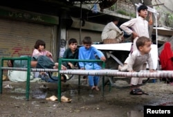 FILE - Refugees, who fled the military offensive against the Pakistani militants in North Waziristan, sit on a bed in Bannu, Khyber-Pakhtunkhwa, Pakistan, June 19, 2014.