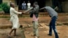 FILE - Muslim men organized in militias with machetes rough up a Christian man while checking him for weapons in the Miskine neighbourhood of Bangui, Central African Republic, Dec. 13, 2013.