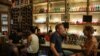 People sit at a bar amid the spread of the coronavirus disease in Athens, Greece, Aug. 1, 2020. 