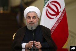 Iranian President Hassan Rouhani speaks with media in a joint press conference with his Austrian counterpart Heinz Fischer after their meeting at the Saadabad Palace in Tehran, Iran, Sept. 8, 2015.