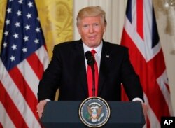 FILE - President Donald Trump reacts to a question from a members of the media during a joint news conference with British Prime Minister Theresa May in the East Room of the White House White House in Washington, Jan. 27, 2017.