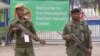 FILE - Armed police officers stand guard outside the presidential election results center in Lusaka, Zambia, Jan, 21, 2015.