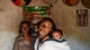 Mebrit Kasua and one of her children at her home in the Tigray Province of northern Ethiopia. Mebrit is a leader in the health development army of women in the Tigray province of northern Ethiopia. The women fight trachoma by providing accurate education