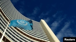 FILE - The flag of the International Atomic Energy Agency (IAEA) flies in front of its headquarters in Vienna, Austria.