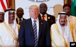President Donald Trump poses for photos with King Salman and others at the Arab Islamic American Summit, at the King Abdulaziz Conference Center, May 21, 2017, in Riyadh, Saudi Arabia.