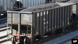 FILE - Coal cars fill a rail yard in Williamson , W.Va., Nov. 11, 2016. The hard-eyed view along the Tug Fork River in coal country is that Donald Trump has to prove he'll help Appalachian mining like he promised.