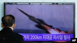 FILE - A South Korean man watches a TV news program showing the file footage of the missile launch conducted by North Korea, at Seoul Railway Station in Seoul, South Korea, March 13, 2015. 