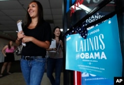 FILE - Two volunteers for President Barack Obama's re-election campaign work to register new voters.