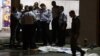 Israeli policemen stand next to the body of a suspected Palestinian attacker, who opened fire on people at a bus station in the southern Israeli city of Beersheva, Oct. 19, 2015.
