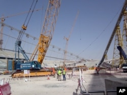 In this photo taken on Nov. 9, 2014, construction work is under way at the Khalifa Stadium in Doha, Qatar. It is one of the venues being redeveloped as Qatar prepares to host the 2022 World Cup.