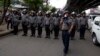 FILE - Police officers stand in position to block activists during a rally in Yangon, Myanmar, May 12, 2018.
