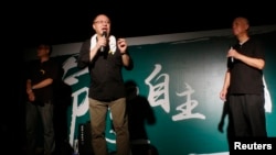 FILE - (L-R) Founders of the Occupy Central civil disobedience movement, academic Chan Kin-man, academic Benny Tai and Reverend Chu Yiu-ming, attend a rally, attended by thousands, in front of the government headquarters in Hong Kong, Sept. 27, 2014. 