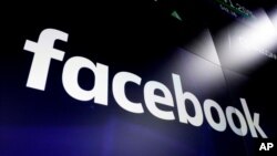 FILE - The logo for social media giant Facebook appears on screens at the Nasdaq MarketSite, in New York's Times Square, March 29, 2018.
