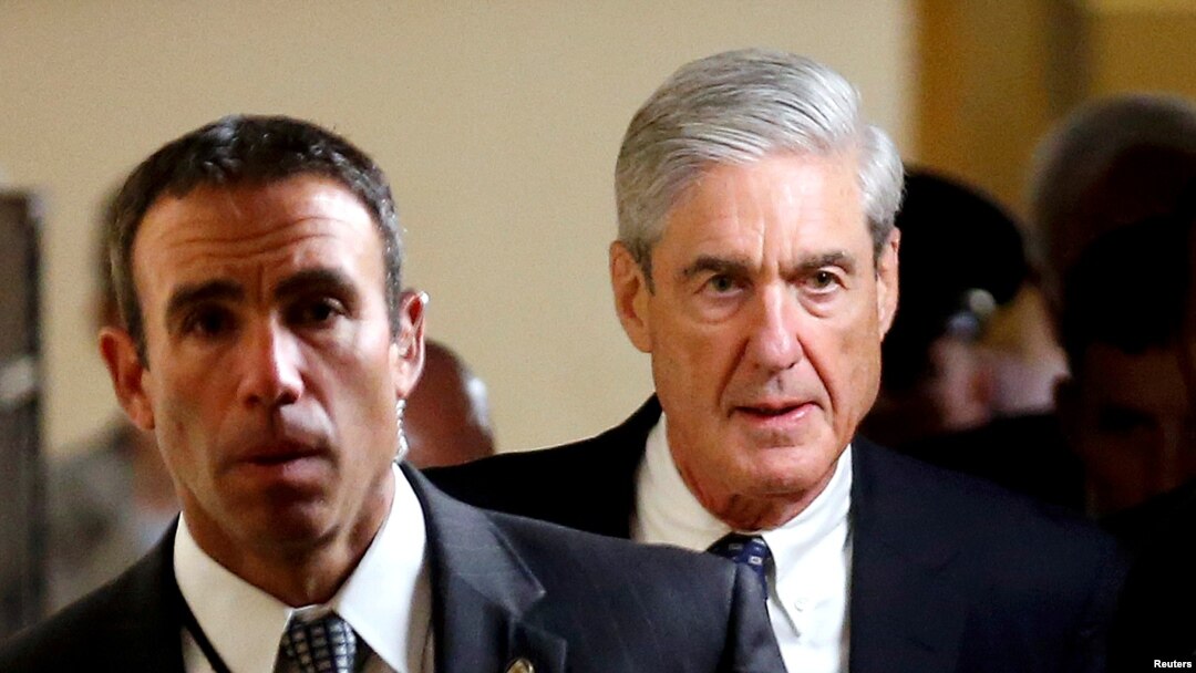 FILE - Special Counsel Robert Mueller (R) departs after briefing members of the U.S. Senate on his investigation into potential collusion between Russia and the Trump campaign on Capitol Hill in Washington, U.S., June 21, 2017. 