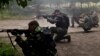 Pro-Russian rebels fire weapons during clashes with Ukrainian troops on the outskirts of Luhansk, Ukraine, June 2, 2014. 