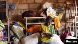 FILE - A displaced boy, who fled with others from his village in northern Burkina Faso following attacks by assailants, is pictured at a school on the outskirts of Ouagadougou, Burkina Faso, June 15, 2019.