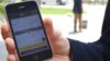 Anton van Metzinger shows how the SnappCab app, which allows users to hail a cab and pay for it electronically, works on his smartphone. (VOA/Peter Cox)