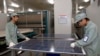 FILE - Employees work on a solar panel production line at Suntech Power Holdings headquarters in Wuxi, Jiangsu. The past few years has seen a plethora of trade disputes as China-made environmental equipment, including solar panels, flooded into western markets. 