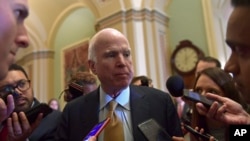 Sen. John McCain, R-Ariz., speaks to reporters following the weekly Republican policy luncheon on Capitol Hill in Washington, Oct. 31, 2017