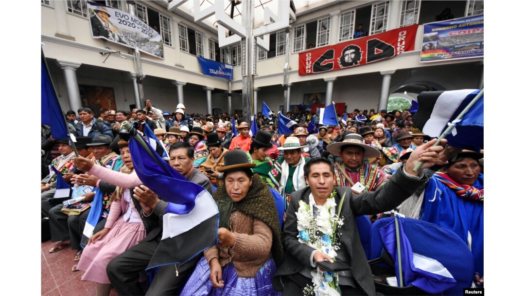 FILE - People attend a signing ceremony of an agreement between Bolivia and China to produce lithium at the salt flat of Coipasa and Pastos Grandes in Oruro, Bolivia, Feb. 6, 2019.