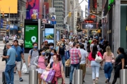 People walk through Times Square on July 13, 2021 in New York City.
