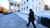 FILE - A Secret Service agent walks near the north portico of the White House on Dec. 2, 2024. 