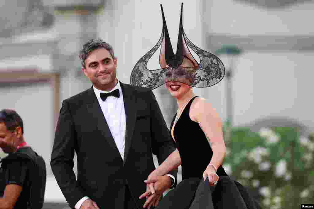 Lady Gaga and her fiancé Michael Polansky pose on the red carpet during arrivals for the screening of the movie "Joker: Folie a Deux", in competition, at the 81st Venice Film Festival, Venice, Italy.