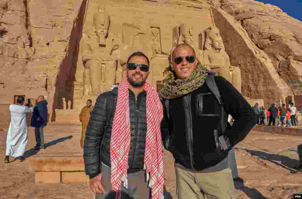 Pablo (L), a Spanish Egyptologist working in Luxor, says "today is special because it is 22/02/2020 and it is the sun festival, we enjoyed the celebration from the beginning to the end.” His friend Mariano (R) came with him. (Hamada Elrasam/VOA)