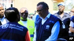 FILE - WHO chief Tedros Adhanom Ghebreyesus speaks to a health official in Beni, Democratic Republic of Congo, Aug. 10, 2018. The WHO has drawn criticism for its slow response to allegations of sexual abuse perpetrated by its own staffers in the country.