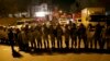 FILE - Iranian security stand guard to protect Saudi Arabia's embassy in Tehran, Iran, while a group of demonstrators gathered to protest execution of a Shi'ite cleric in Saudi Arabia, Jan. 3, 2016.