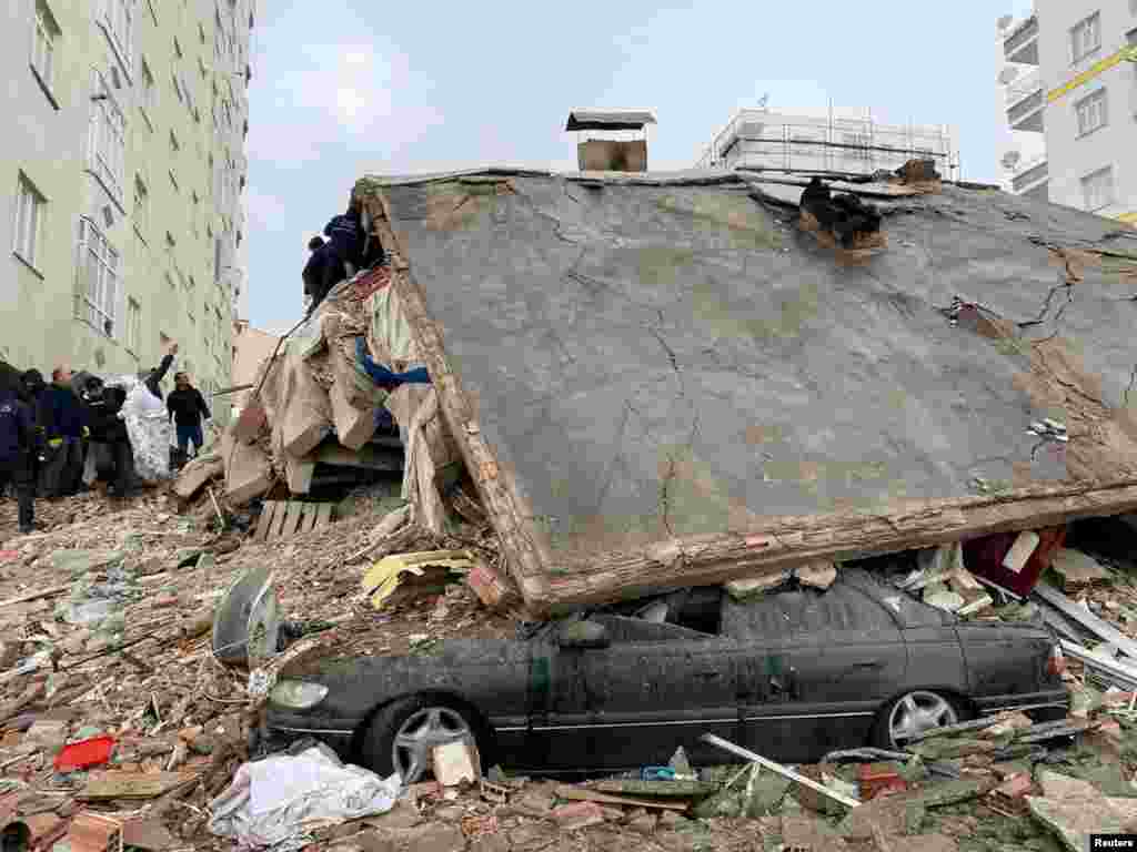 People search through rubble following an earthquake in Diyarbakir, Turkey, Feb. 6, 2023. 