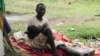 Suspected carrier of Ebola virus James Flomo sits in isolation with his child in Monrovia, Liberia, Jan. 21, 2015. African leaders are due to disucuss Ebola crisis during the summit in Addis Ababa, Ethiopia.