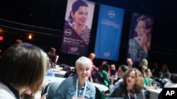 FILE - Dell Women’s Entrepreneur Network attendees talk before a panel featuring Dell Inc. founder Michael Dell, not pictured, in Austin, Texas, June 2, 2014. 
