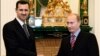 FILE - In this Tuesday, Dec. 19, 2006 file photo Vladimir Putin, then Russian President, right, and his Syrian counterpart Bashar Assad smile as they shake hands in Moscow's Kremlin 