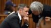 Former Paralympian Oscar Pistorius is comforted by an unidentified woman before his sentencing for the murder of Reeva Steenkamp at the Pretoria High Court, South Africa, June 13, 2016. 