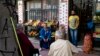 Men sit outside a grocery shop in Athens, June 5, 2020. The European Commission says Greece is likely to suffer deepest recession in the eurozone this year, but first quarter growth figures were better than expected.