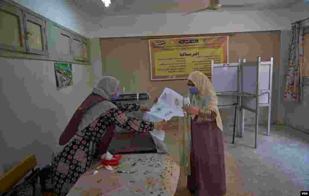 Women work on election duties in Cairo, Aug. 11, 2020. The new senate will have 200 elected members, and 100 appointed directly by the president. Results are expected August 19.