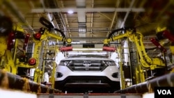 FILE - More automation at factories across the globe means fewer people on the production line.
