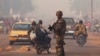 A French soldier waves through traffic as he mans a roadblock in the Miskine neighborhood of Bangui, Central African Republic, Jan. 6, 2014. 