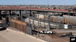In this Tuesday, Jan. 22, 2019, photo, a new barrier is built along the Texas-Mexico border near downtown El Paso. Such barriers have been a part of El Paso for decades and are currently being expanded.