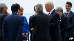 President Donald Trump poses for photos with G7 leaders at the Ancient Greek Theater of Taormina during the G7 Summit, May 26, 2017, in Taormina, Italy.