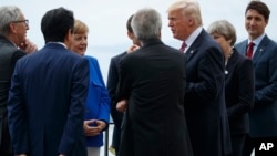 President Donald Trump poses for photos with G-7 leaders at the Ancient Greek Theater of Taormina during the G-7 Summit, May 26, 2017, in Taormina, Italy.