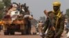 A Chadian soldier, part of the African Union (AU) peacekeeping mission in the Central African Republic, keeps guard during the beginning of a road repatriation to Chad in the capital Bangui, Jan. 22, 2014. 
