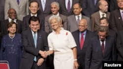 International Monetary Fund (IMF) Managing Director Christine Lagarde shakes hands with Japanese Finance Minister Koriki Jojima before posing for a group photograph in Tokyo, October 12, 2012.