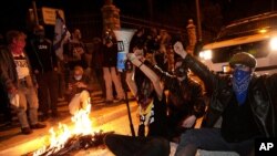 Israeli protesters chant slogans and block a road during a demonstration against Israeli Prime Minister Benjamin Netanyahu near his official residence in Jerusalem during the third nationwide coronavirus lockdown, Jan. 2, 2021.