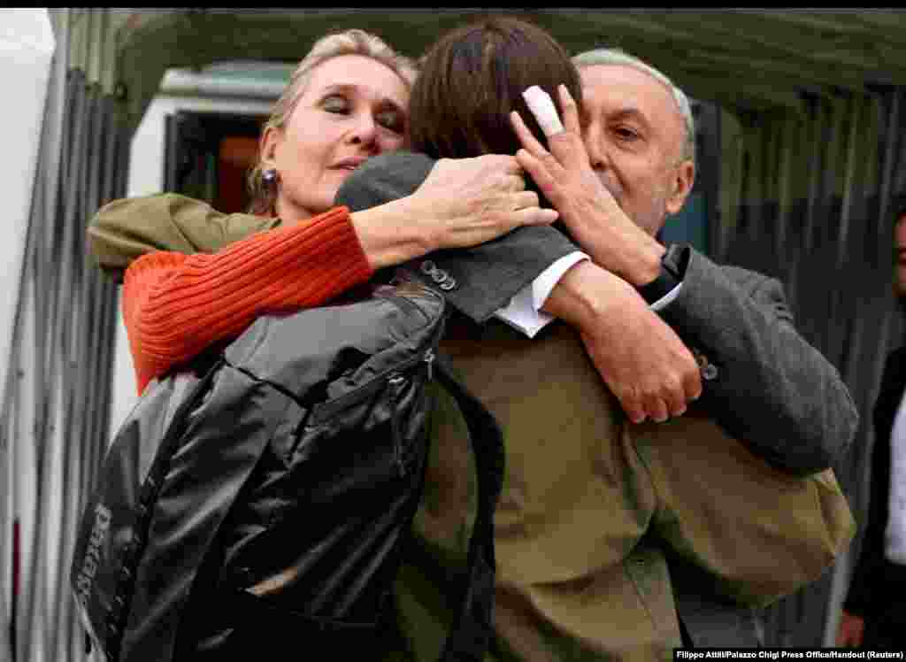 Italian journalist Cecilia Sala hugs her parents Elisabetta Vernoni and Renato Sala at Rome's Ciampino military airport after she was freed from detention in Iran.