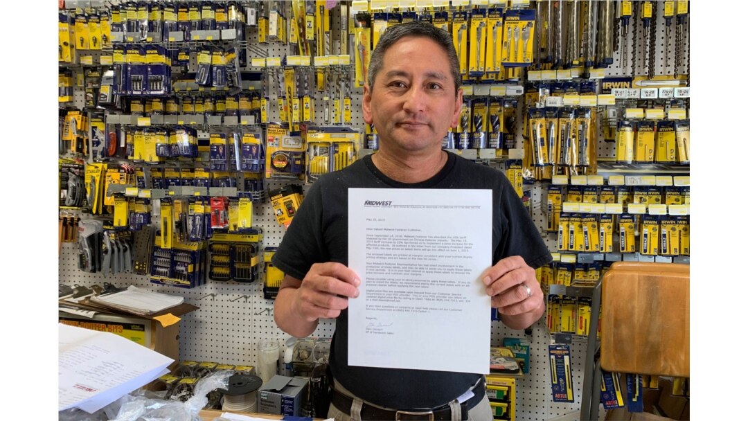 Albert Chow, owner of Great Wall Hardware in San Francisco, Aug. 28, 2019, holds a letter from a supplier notifying him that prices will be increasing 10% to 18% because of U.S. tariffs on Chinese goods.